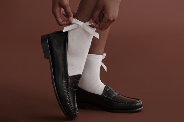 Women's elegant white crew socks with a cute bow detail paired with black loafers
