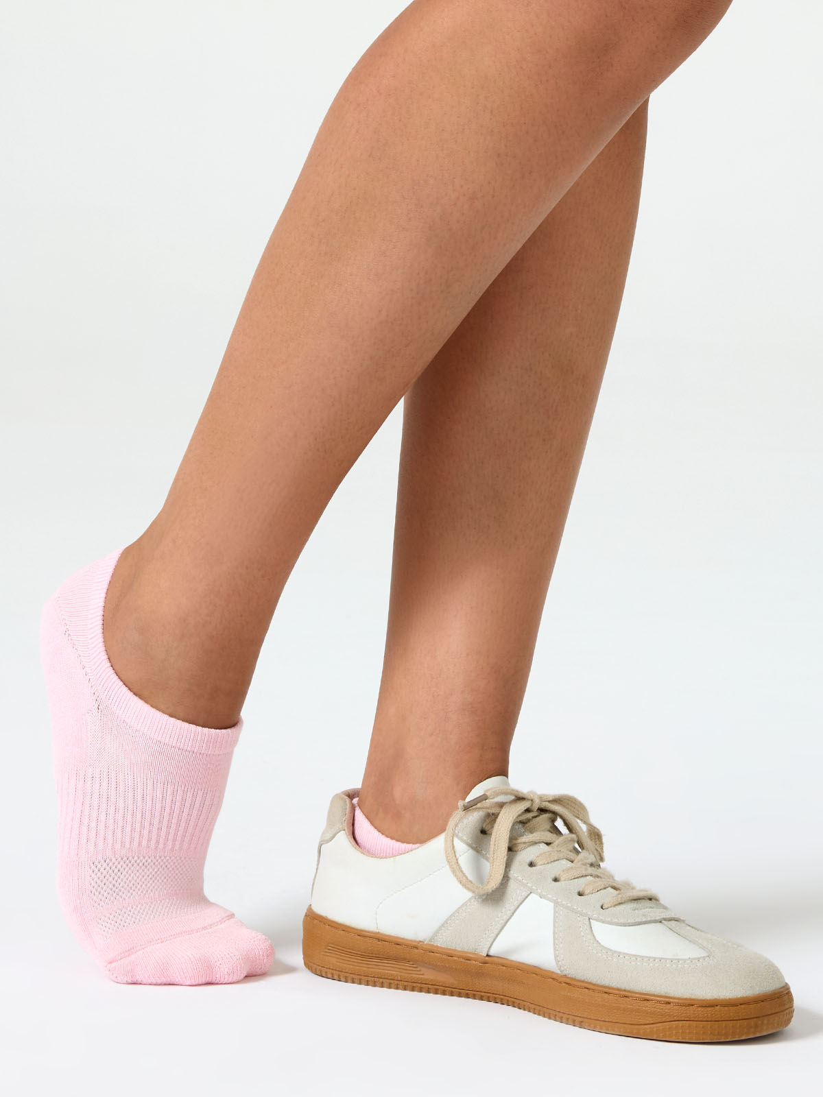 A detailed close-up product photograph of Closemate's pink ribbed cotton no-show invisible boat socks, set against a smooth, neutral beige background. The image clearly highlights the breathable fabric texture, the precise contoured fit around the foot, and the intricate patterned weave on the footbed designed for comfort.
